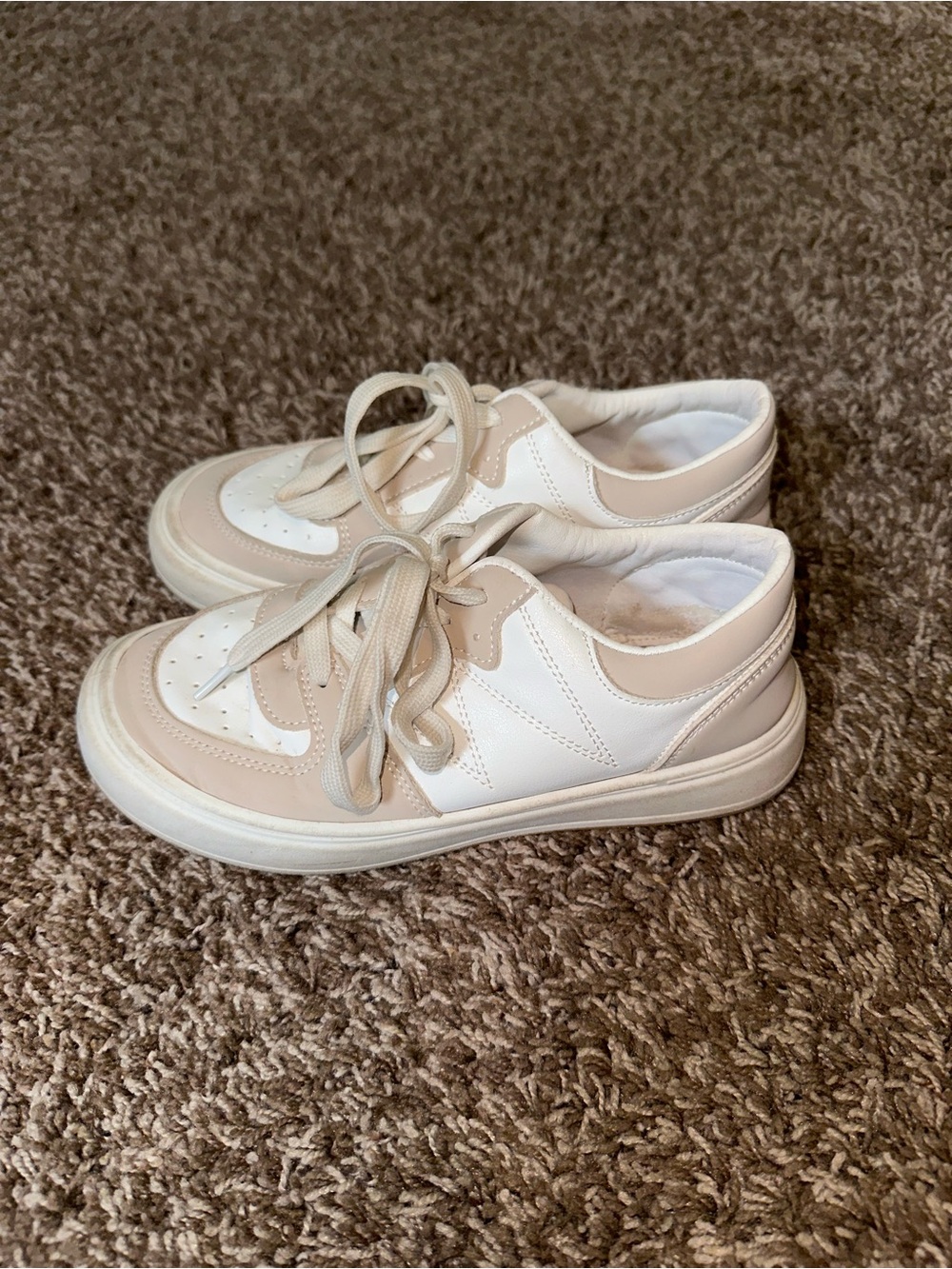 Women’s tan and white sneakers